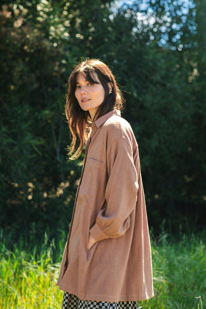 Indulge in the timeless appeal of this artist smock, tailored for both artists and creatives, as well as individuals seeking a stylish layer for their ensemble. The rich rusty brown hue adds a distinctive touch, seamlessly complementing any outfit for an elevated look. Featuring full sleeves, button closure, and a convenient front pocket, this smock offers both practicality and sophistication in one.