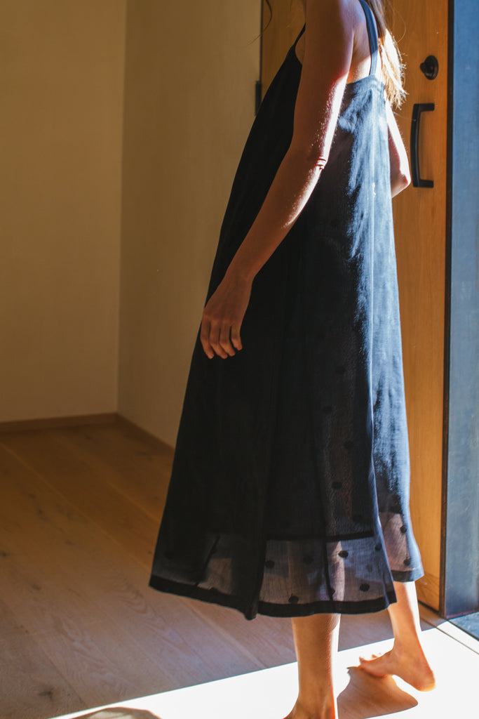 This Everywhere dress is made in collaboration between Erica Kim and World of Crow, it's sleeveless, black in color, Jamdani fabric, Midi length, Sustainably made