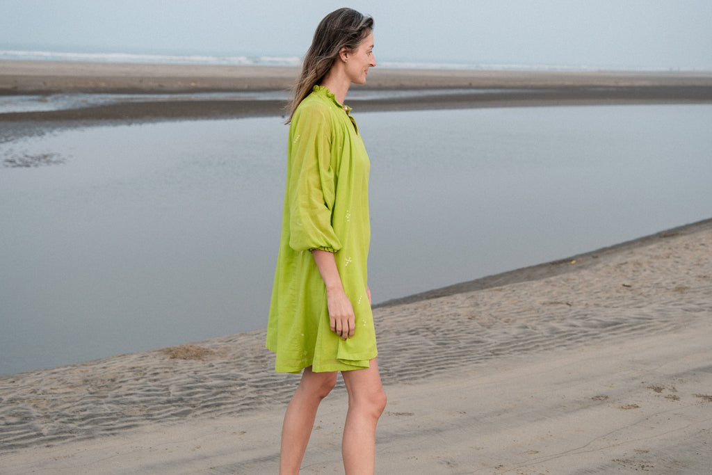This Pride of Crow mini dress is made in collaboration between Erica Kim and World of Crow, it has a frilled round V-neckline, Sorbet green colour, A-line flare, Drop shoulders, Long gathered cuff sleeves, side pockets, Oversized fit in Jamdani fabric