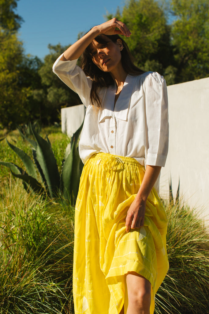 This Lemon Sorbet Skirt is made in collaboration between Erica Kim @ahistoryofarchitecture and World of Crow, it has a yellow color, checks detailing, jamdani fabric, ankle length skirt