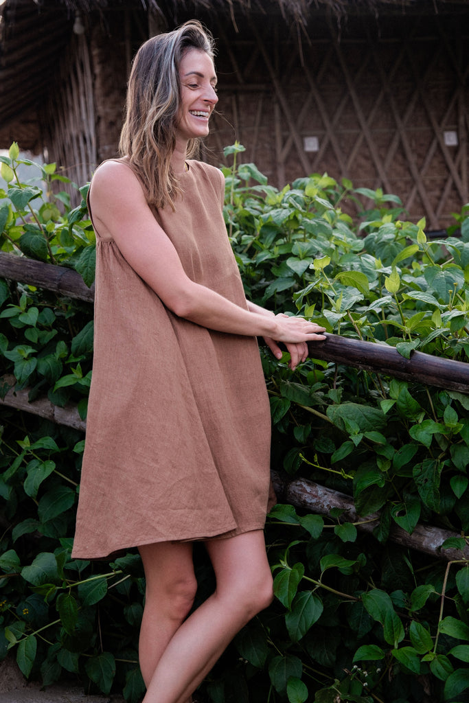 This noon dress is made in collaboration between Erica Kim and World of Crow, it has linen fabric, Brown rustic color, sleeveless, above knee-length dress, it is sustainably made and true to size